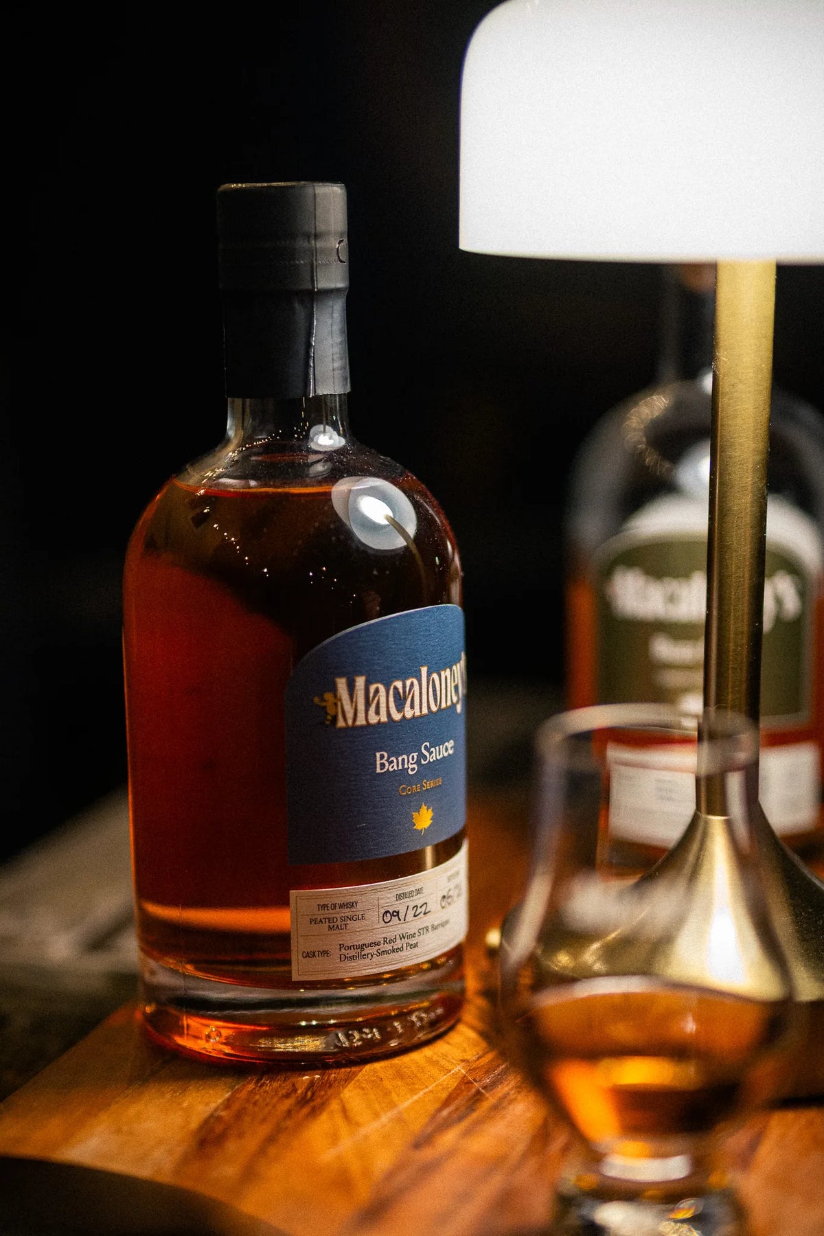 Macaloney's Bang Sauce red wine cask, lightly peated single malt whisky on a lamp lit tasting table